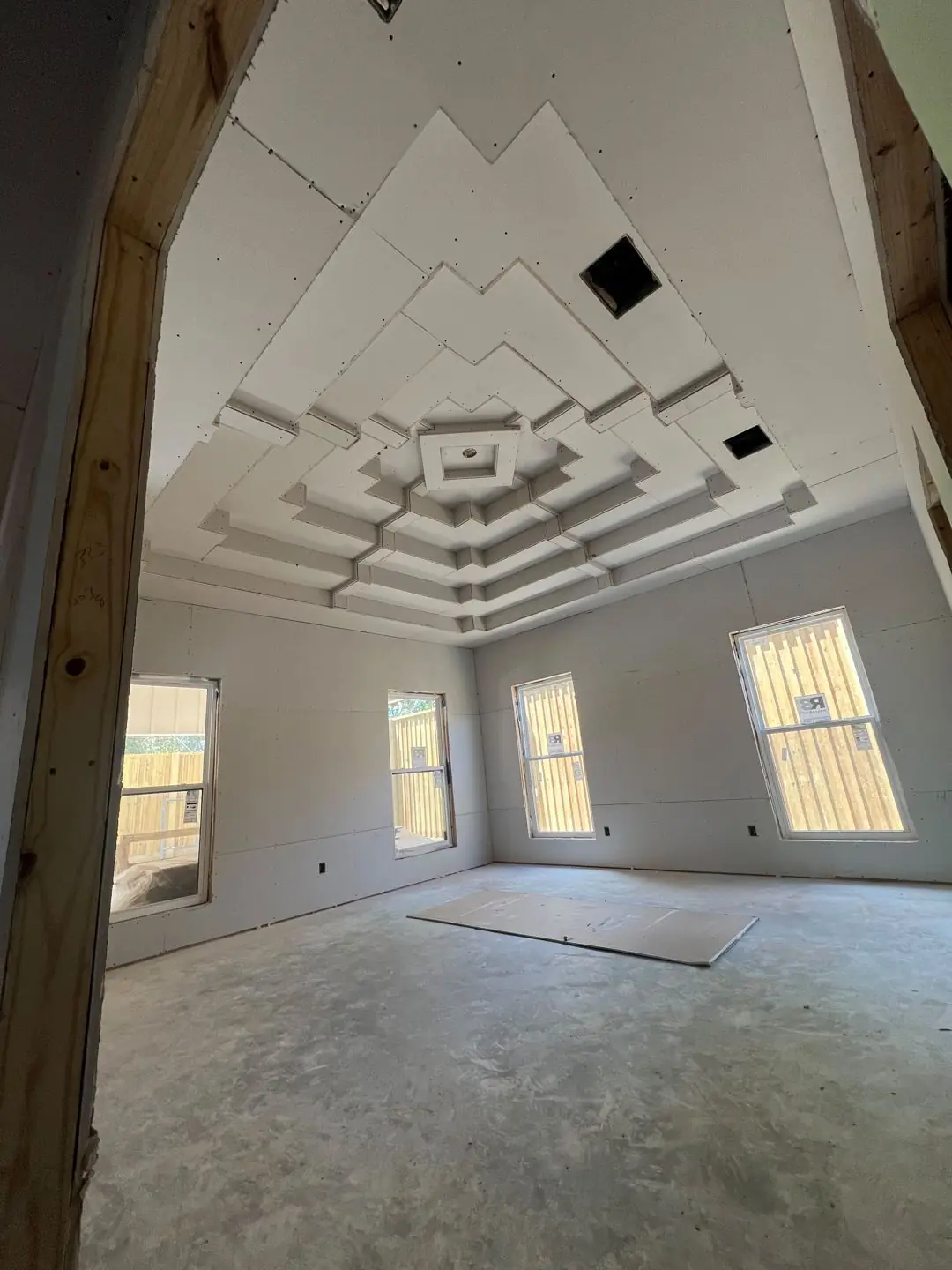 Drywall stage, tray/coffer ceilings, exposed beams, vaulted