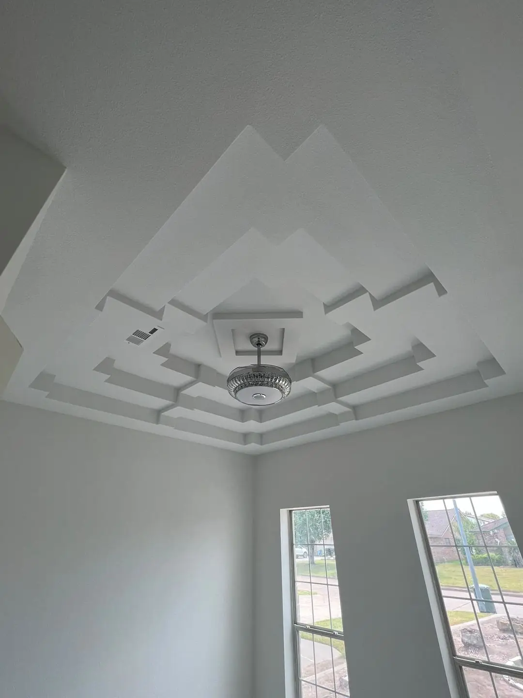 Finished tray ceilings, one with wood plank inlay