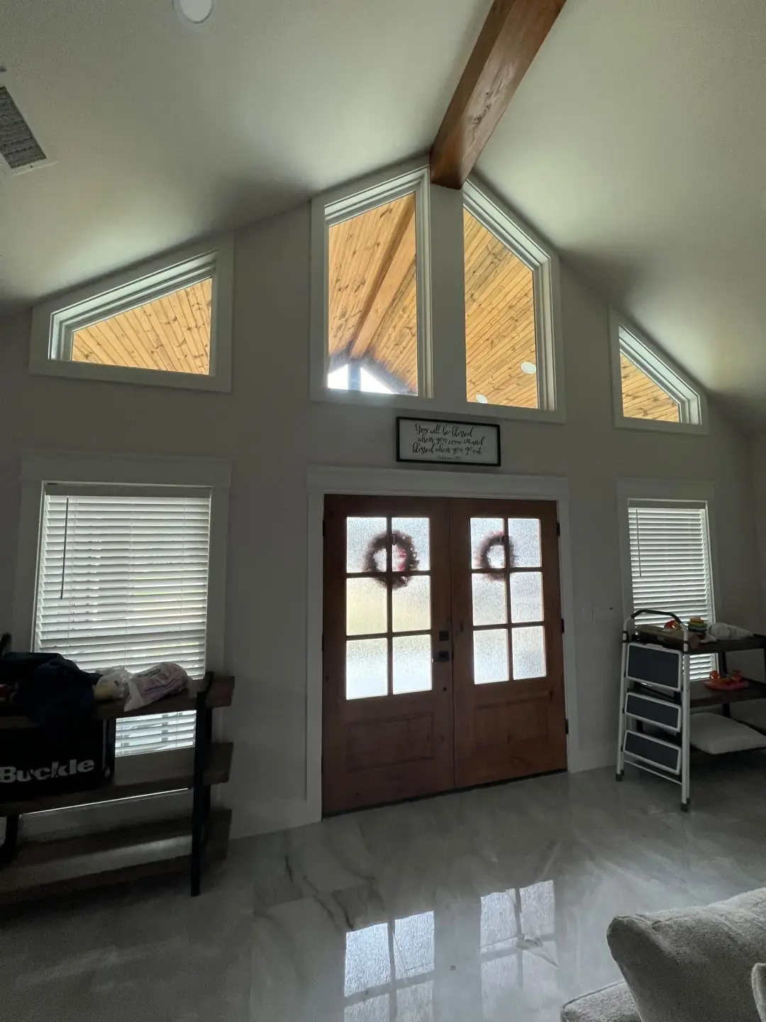Finished entry: double stained wood doors, gable, porch, tile floor inside
