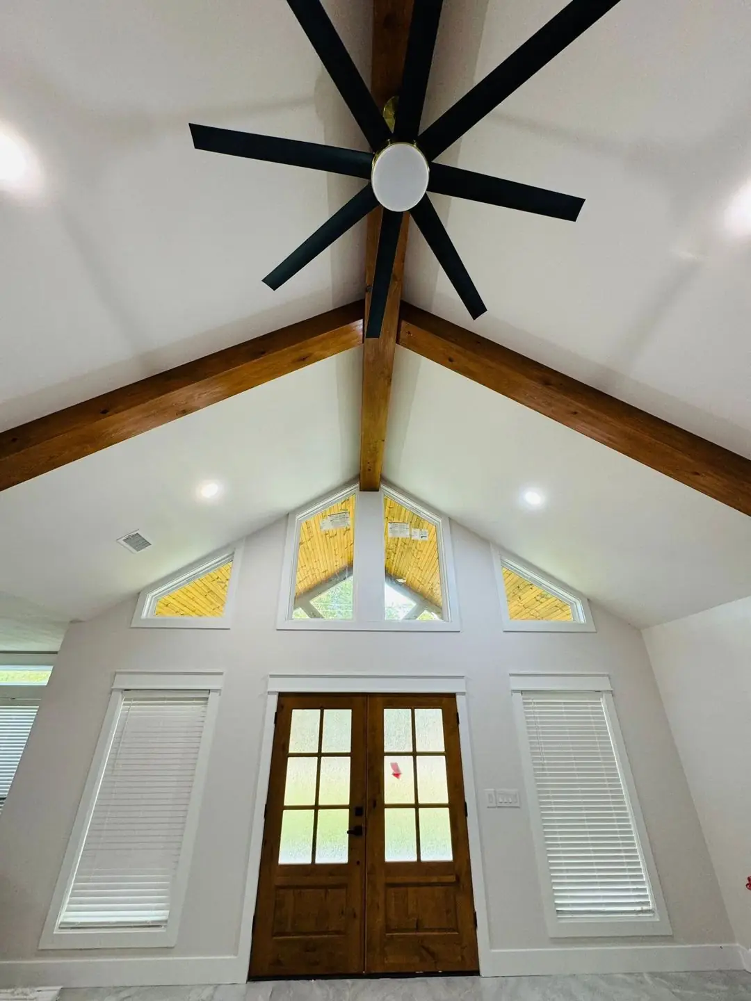 Finished living/kitchen: vaulted beams, fan medallions, marble tile