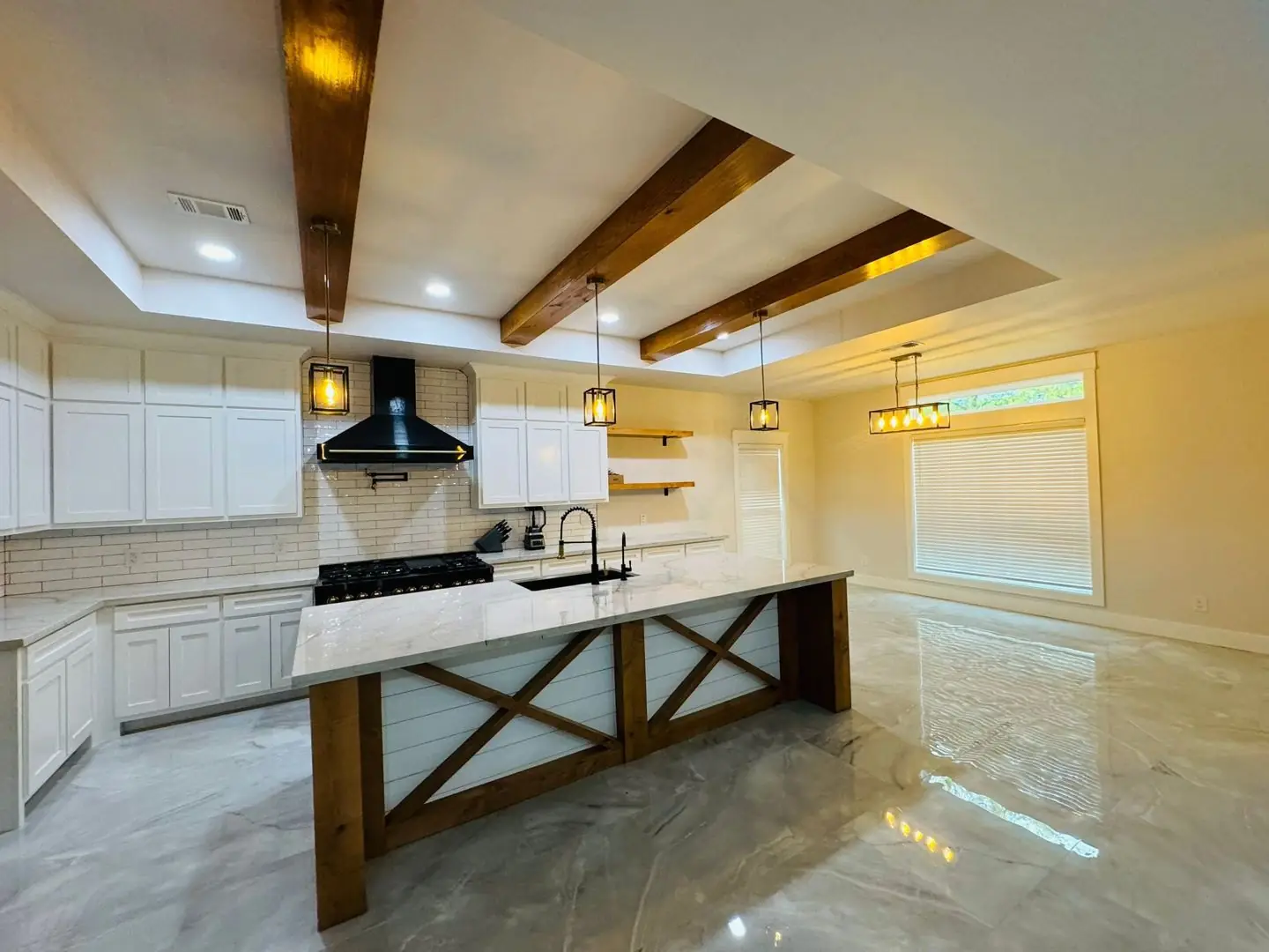 Finished living/kitchen: vaulted beams, fan medallions, marble tile