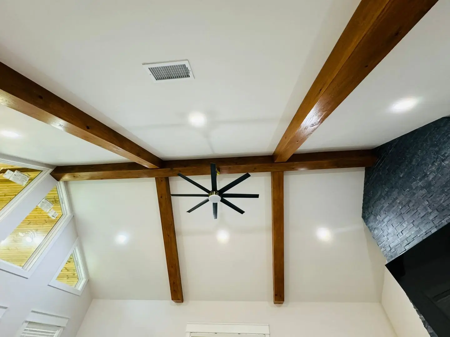 Finished living/kitchen: vaulted beams, fan medallions, marble tile