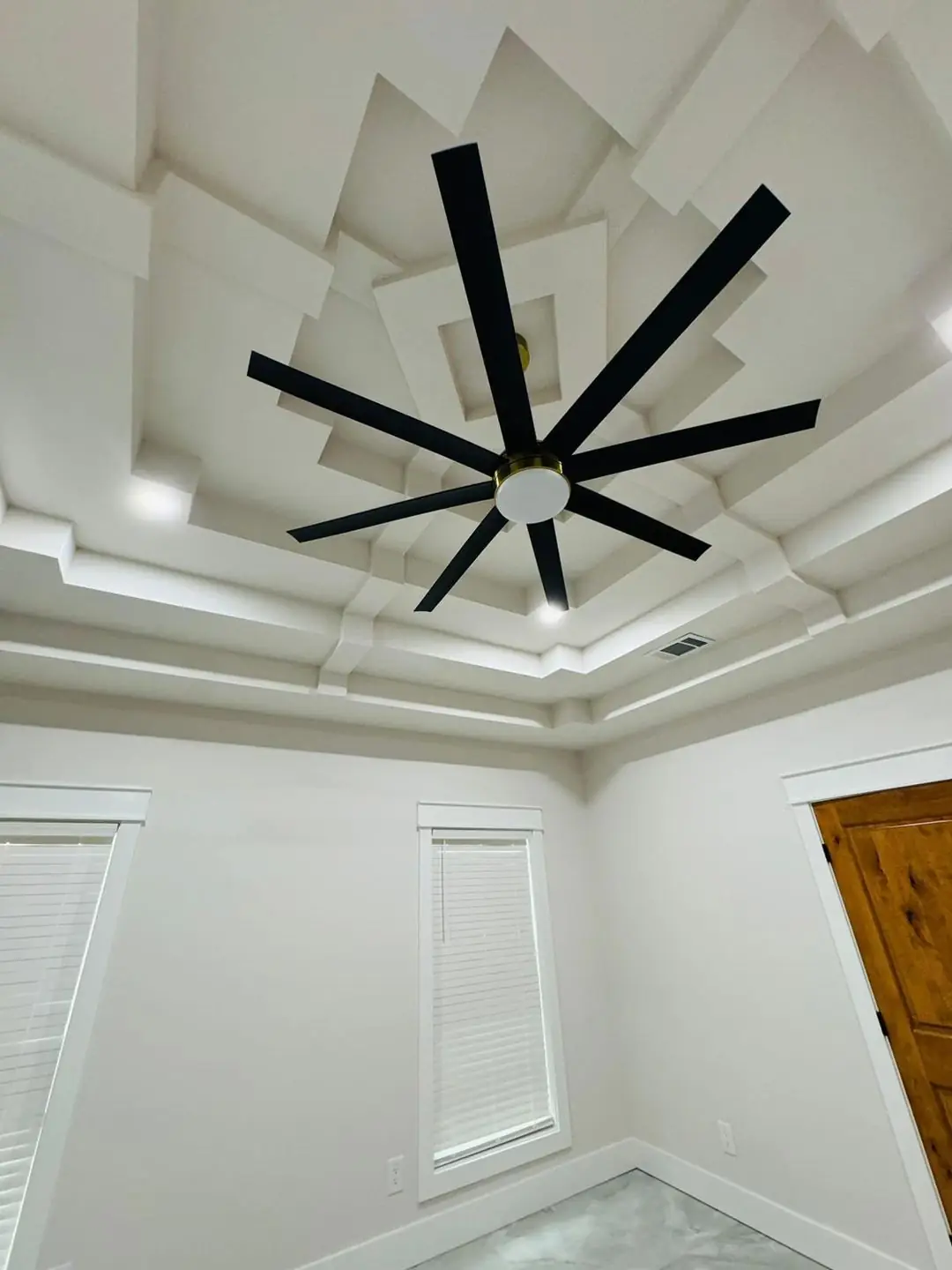 Finished living/kitchen: vaulted beams, fan medallions, marble tile