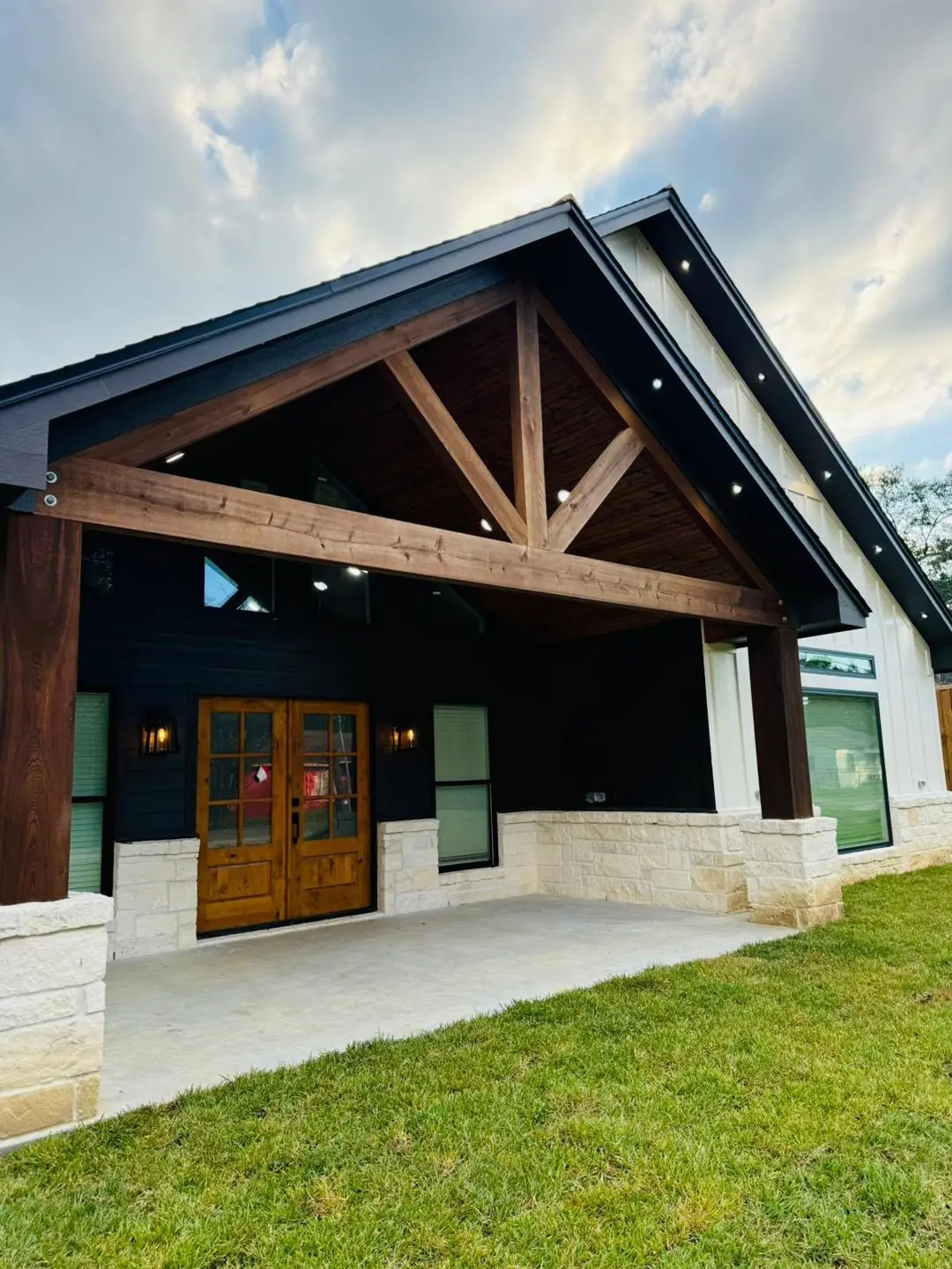 Gable porch exterior w/ timber trusses and stone