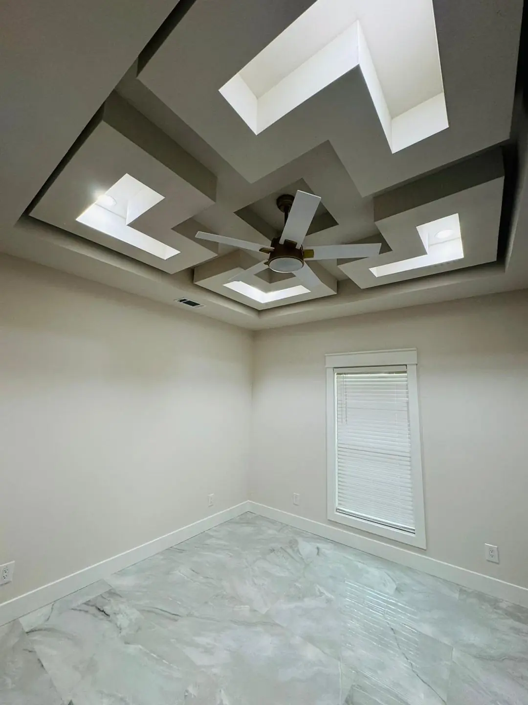 Finished living/kitchen: vaulted beams, fan medallions, marble tile