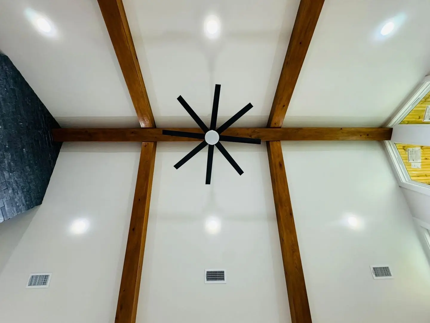 Finished living/kitchen: vaulted beams, fan medallions, marble tile