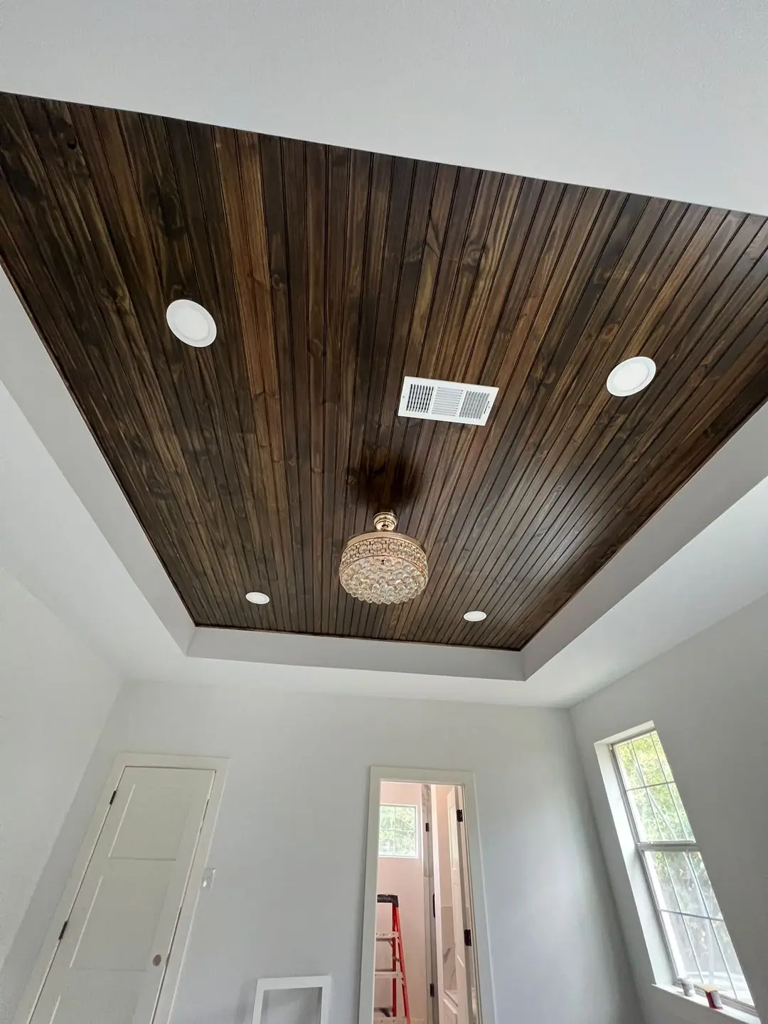 Finished tray ceilings, one with wood plank inlay