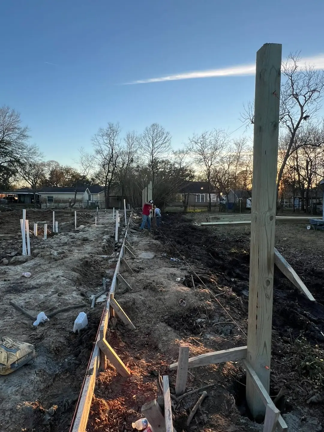 Slab prep: forms, pipe stub-outs, treated posts/fence