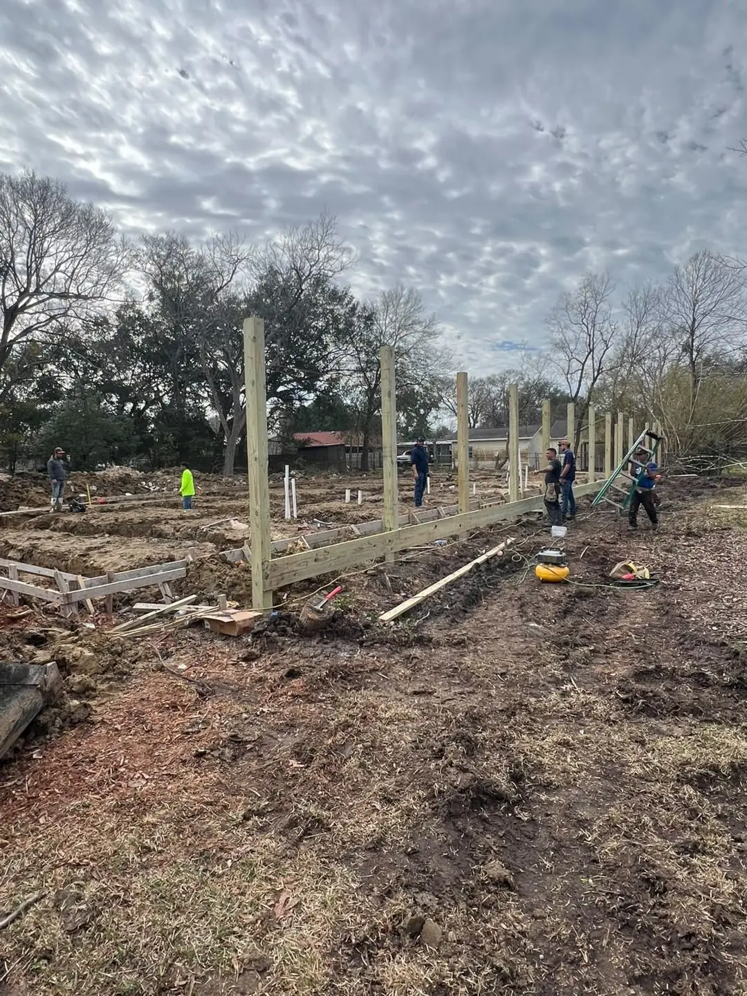Slab prep: forms, pipe stub-outs, treated posts/fence