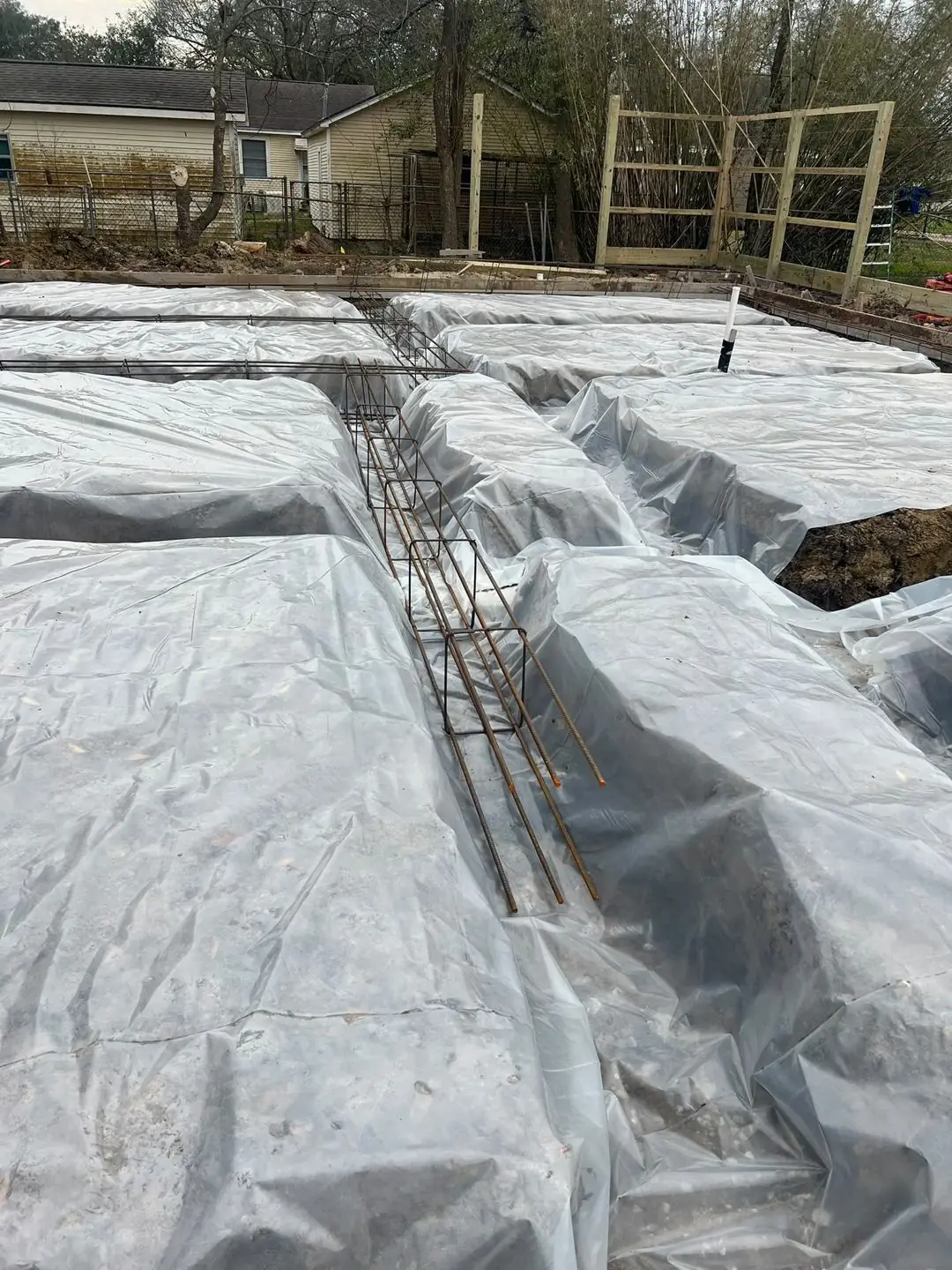Slab prep: forms, pipe stub-outs, treated posts/fence