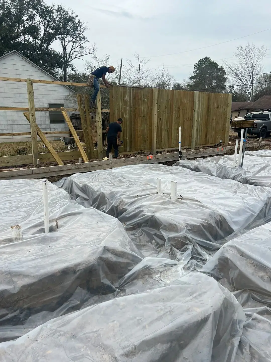 Slab prep: forms, pipe stub-outs, treated posts/fence