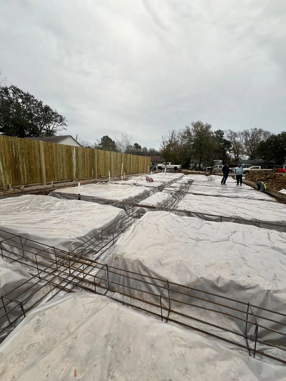 Slab prep: forms, pipe stub-outs, treated posts/fence