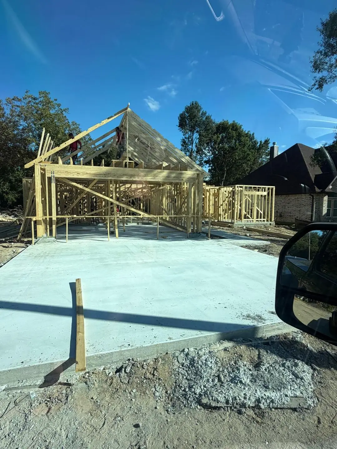 Framing walls/roof trusses going up on finished slab