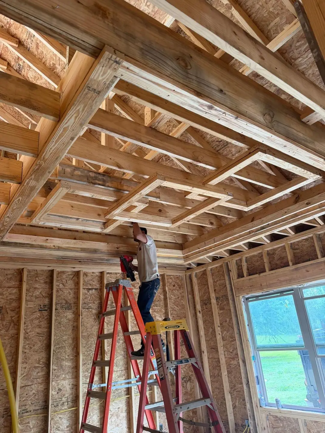 Interior framing, tray/coffered ceiling frame, worker on ladder, Port Acres, TX