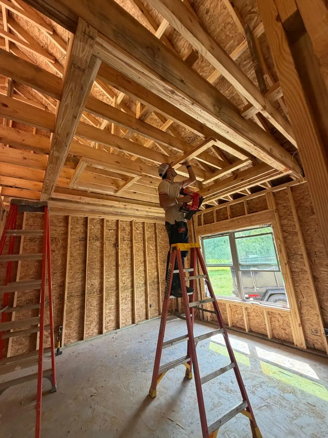 Interior framing, tray/coffered ceiling frame, worker on ladder, Port Acres, TX
