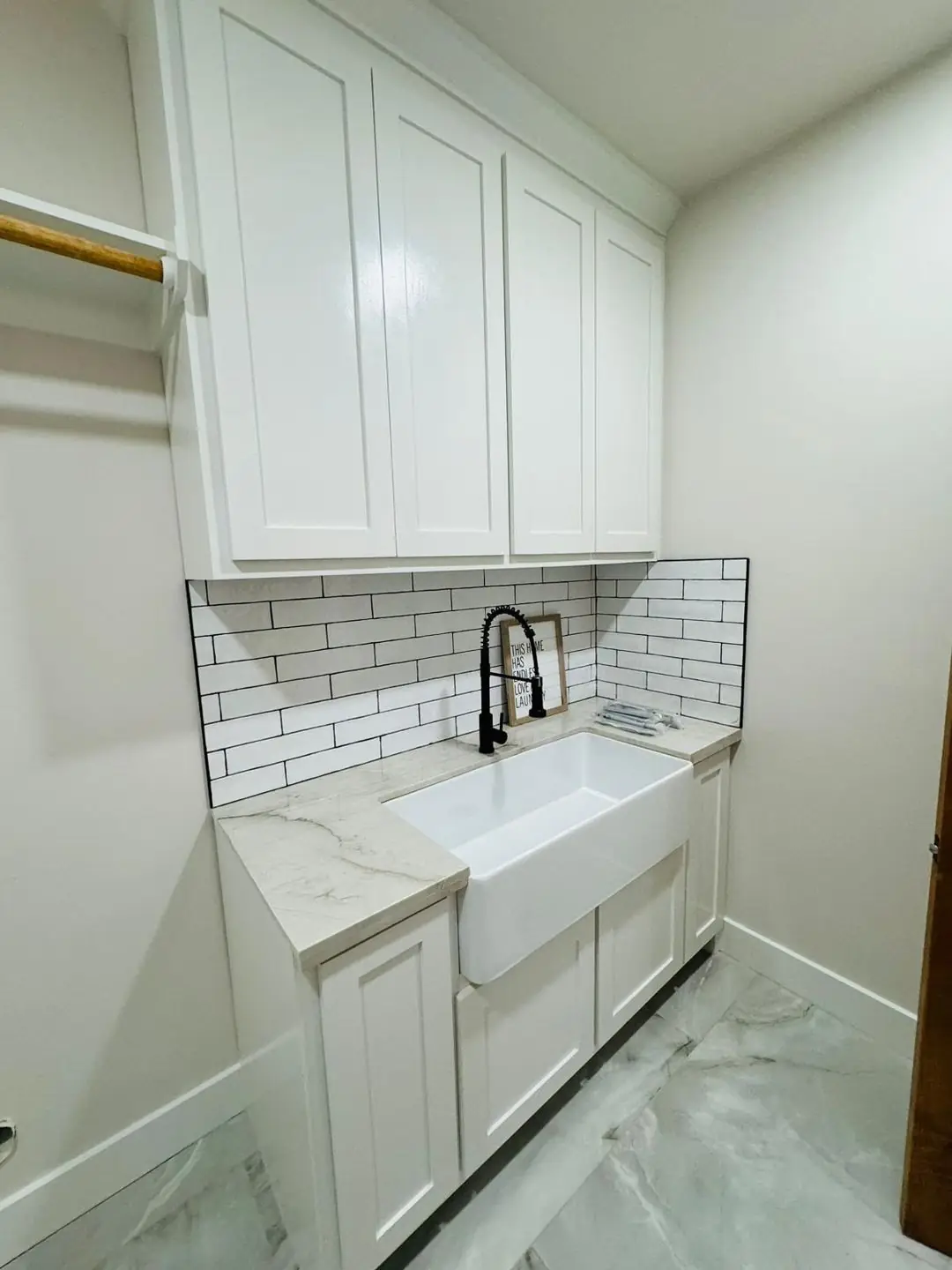 Finished half bath/laundry sink area, round/arched mirrors