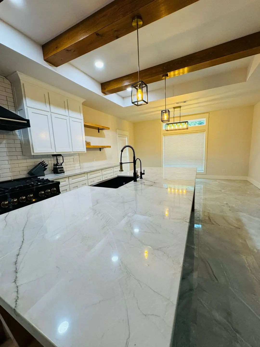 Finished living/kitchen: vaulted beams, fan medallions, marble tile