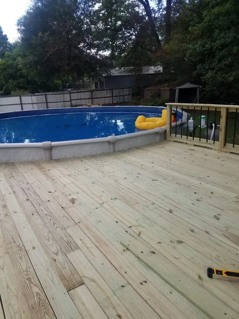 Wood deck + stairs around above-ground pool, railings, Groves, TX