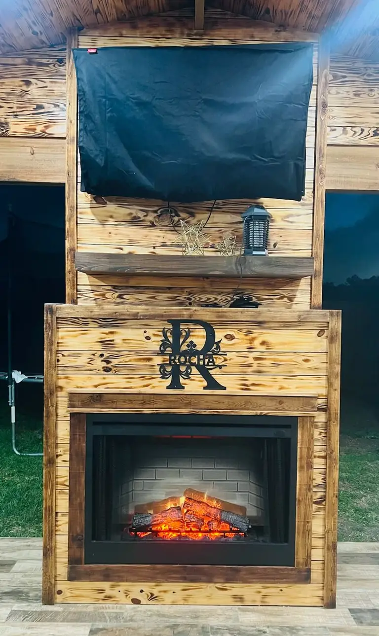 Outdoor fireplace/TV wall under construction, R monogram, wood-burned surround