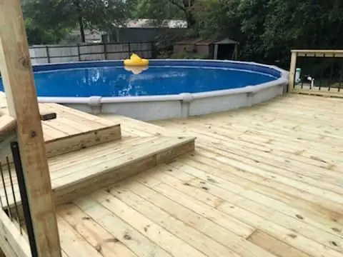 Wood deck and stairs around an above-ground pool, Groves, TX