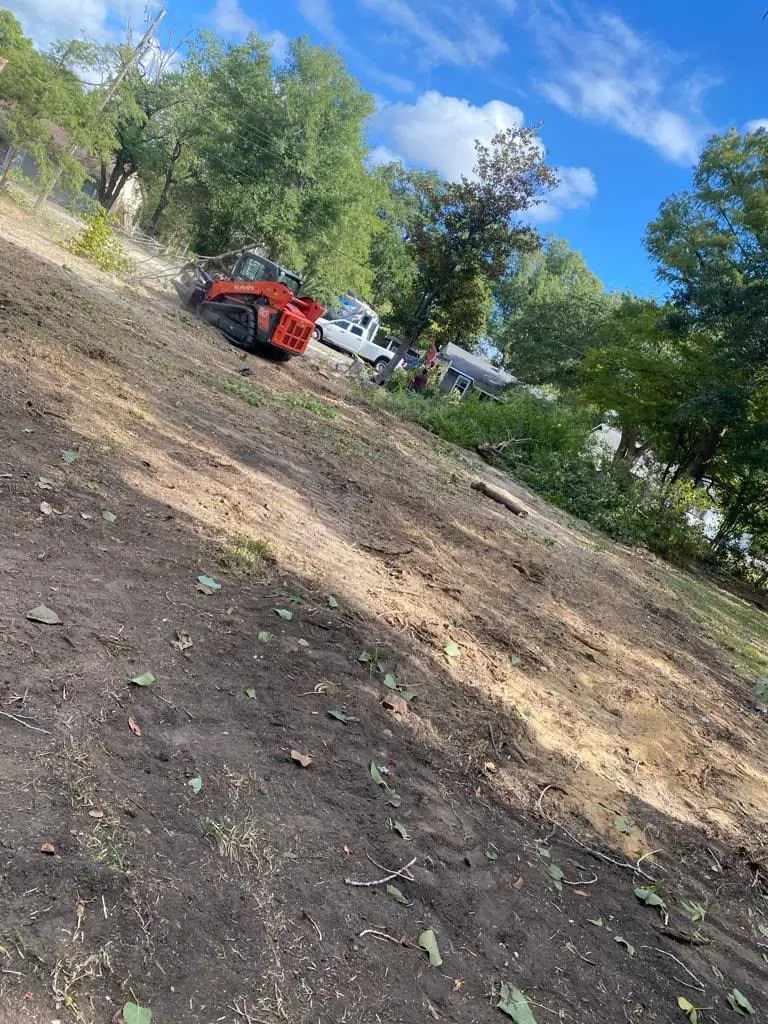 Skid steer working a sloped lot