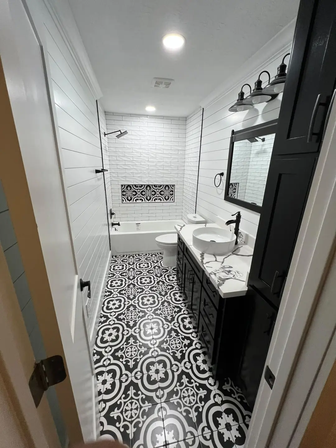 Guest bath with patterned floor tile and shiplap walls