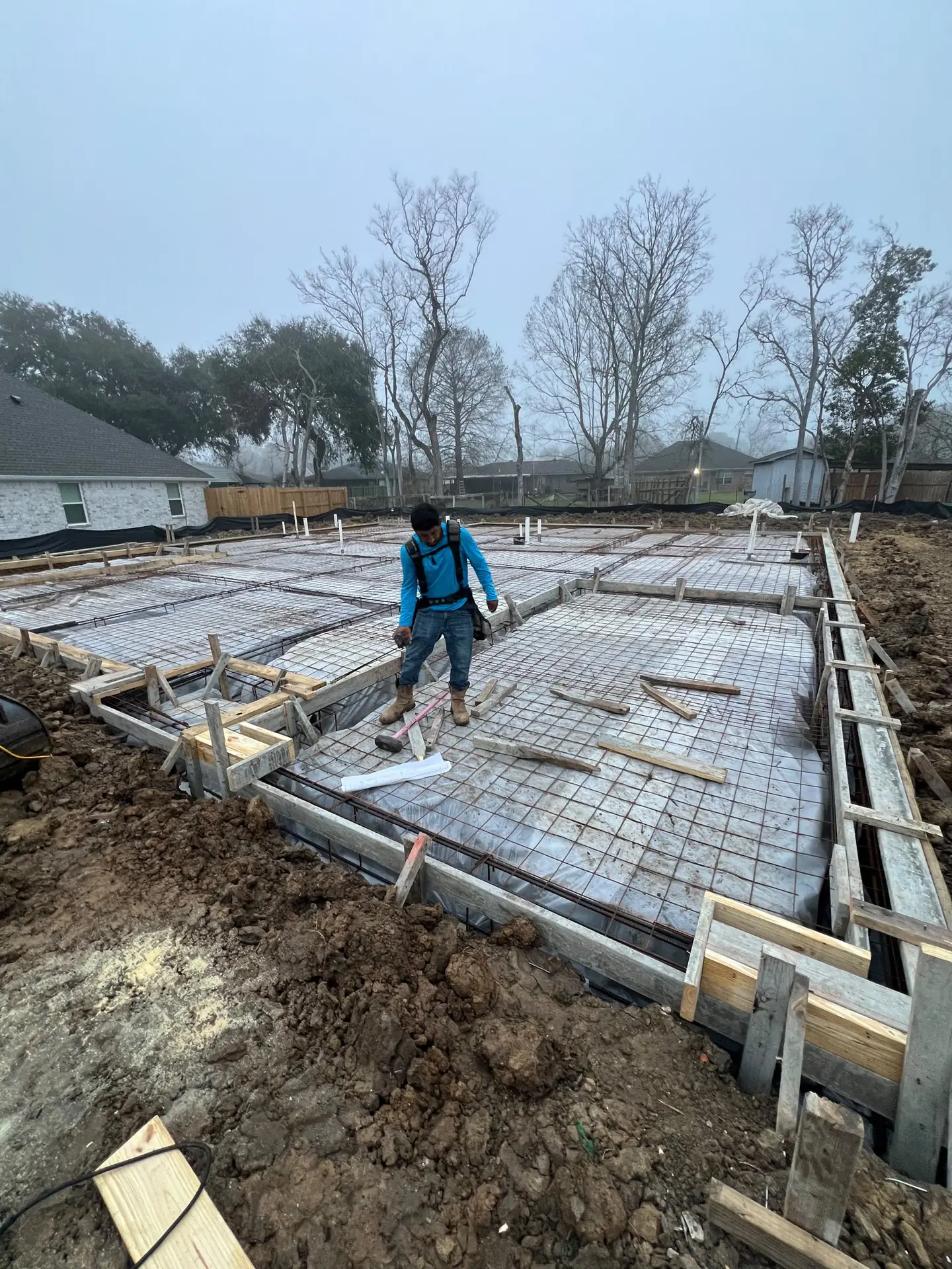 Rebar and plumbing laid out in the forms before a slab pour